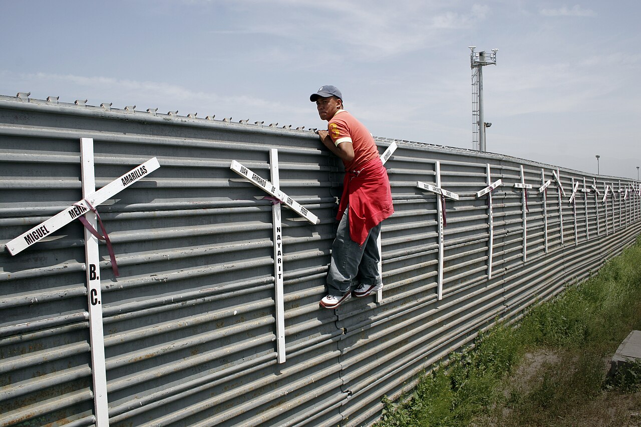 Aspiring migrant from Mexico into the US at the Tijuana-San Diego border. The crosses represent the deaths of failed att