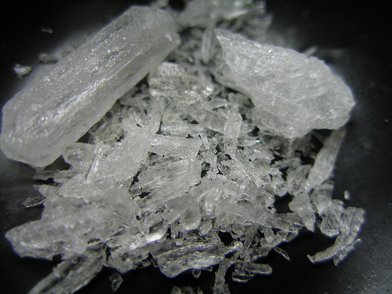 Photograph of crystal methamphetamine in a black background