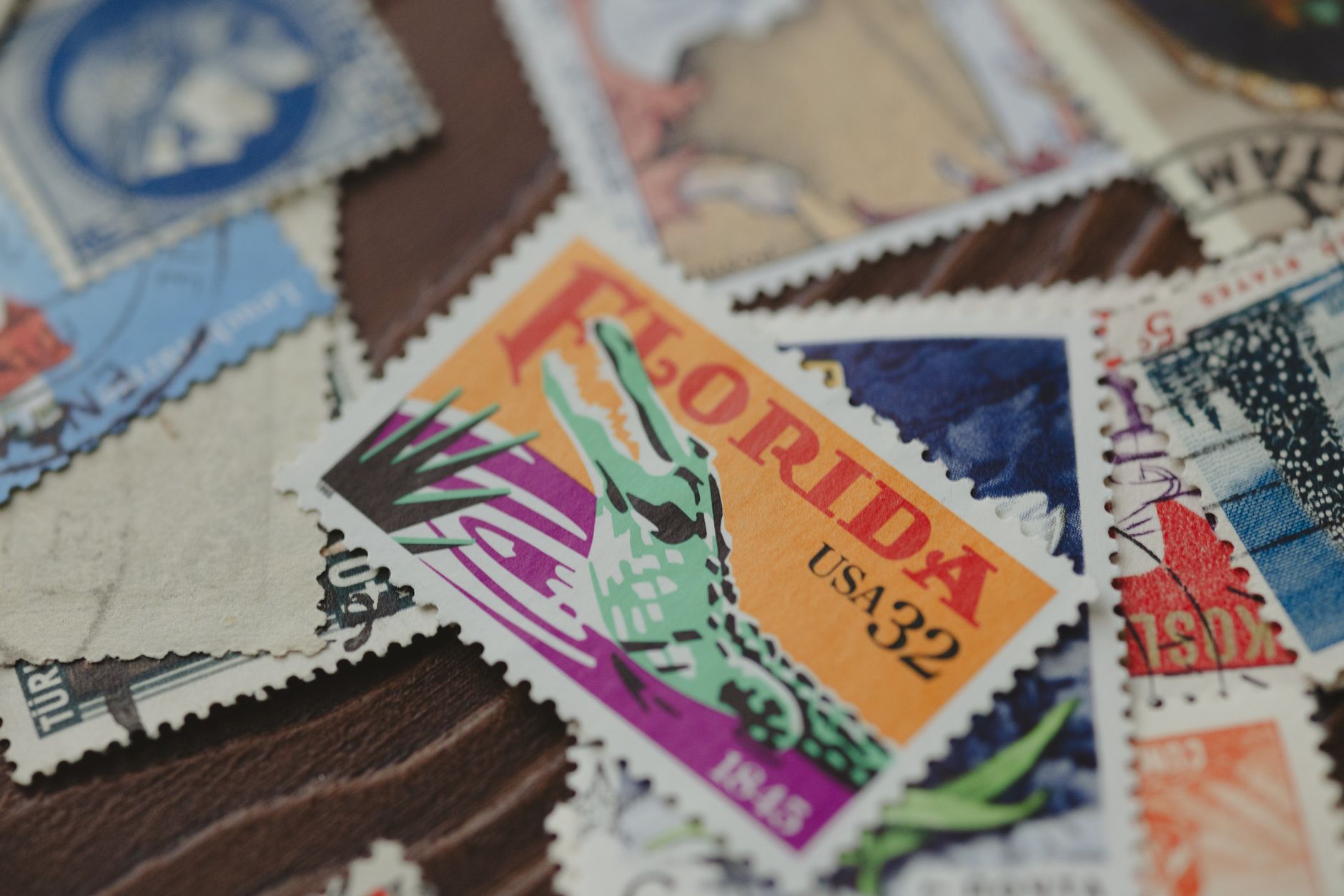 Close-up of diverse vintage stamps, featuring a Florida stamp. Captures postal history and design art.