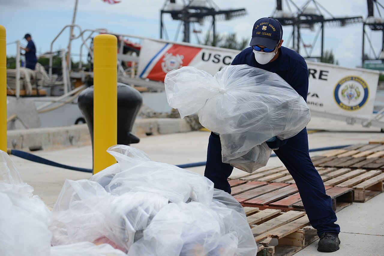 A crew member aboard the Coast Guard Cutter Legare offloads seized cocaine at Coast Guard Base Miami Beach, Florida, Sep