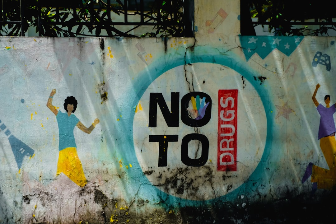 Graffiti art with "no to drugs" message and dancing figures.